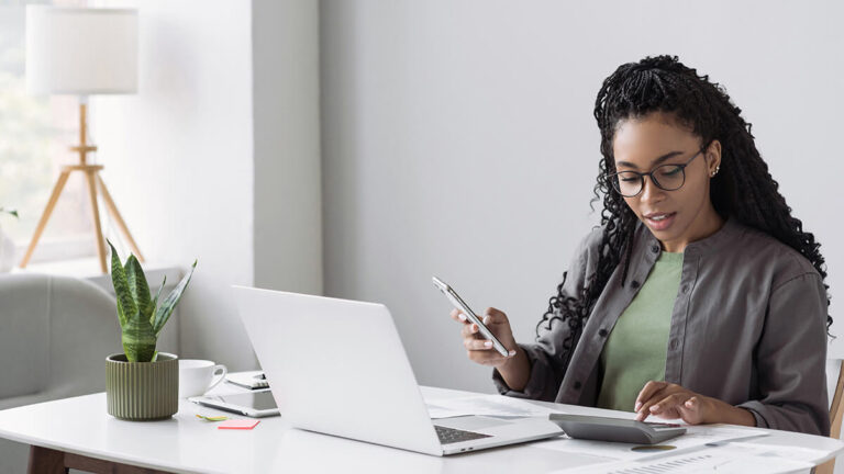 Woman comparing business loan rates on cell phone.