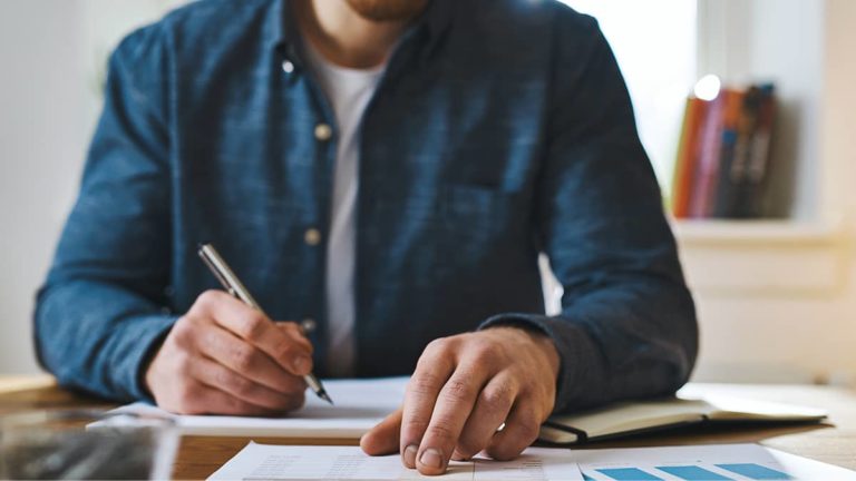 Man filling out paperwork.