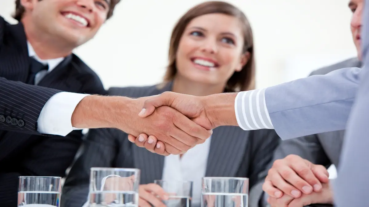 a group of people shaking hands and smiling