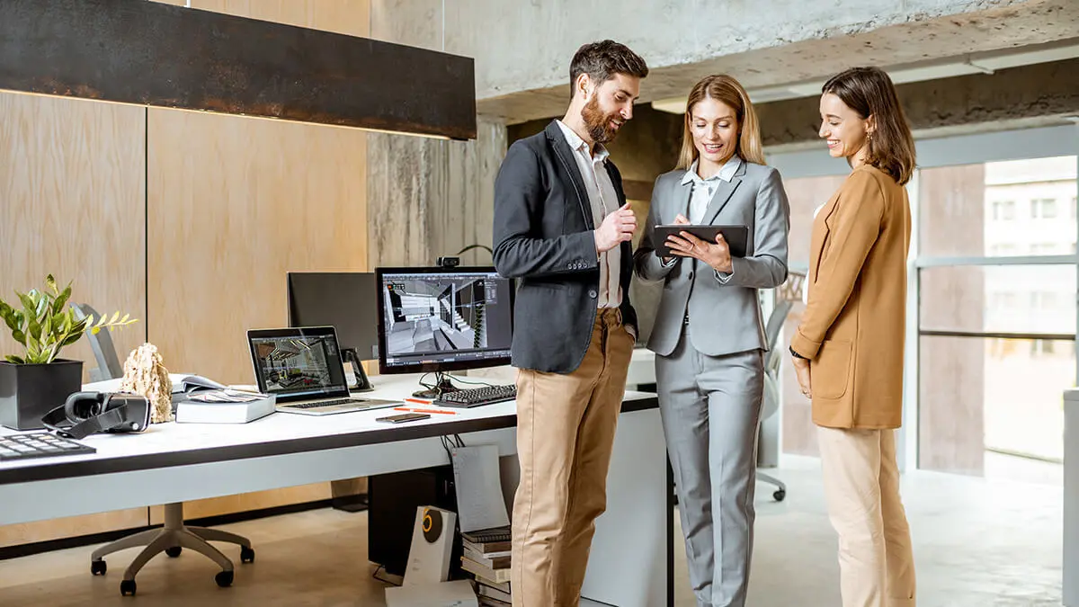 Team of employees looking at tablet