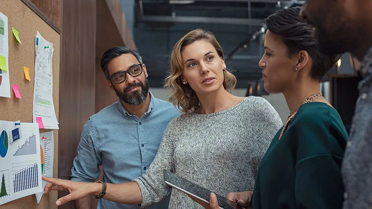 Three co-workers looking at accounting KPIs.