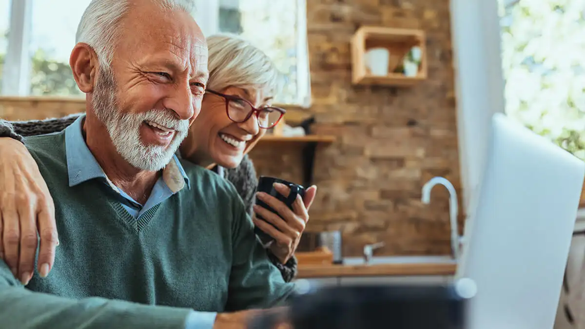 Older couple happily reviewing retirement plans.