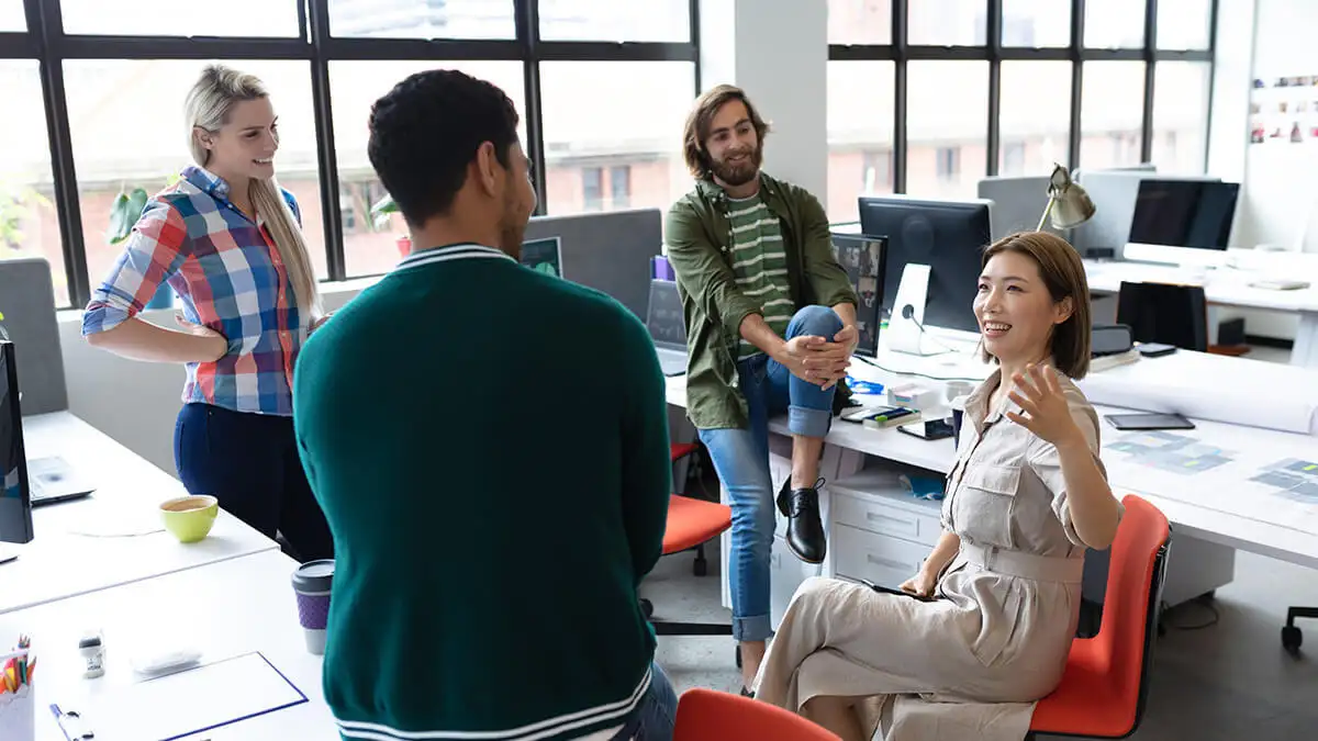 Four smiling employees talking