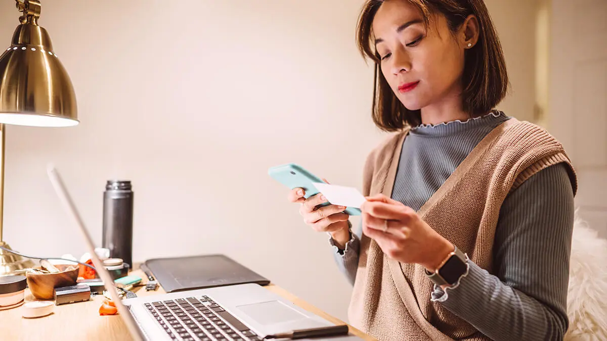 Woman looking at insurance card