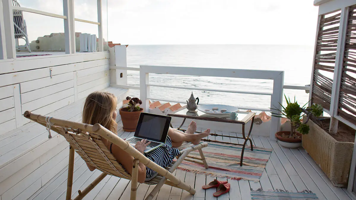 Employee with a flexible work arrangement at a beach house