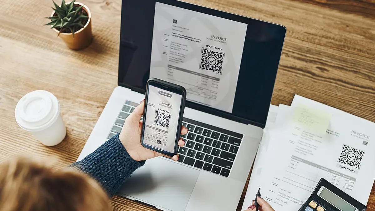 Customer scanning a QR code to pay invoice