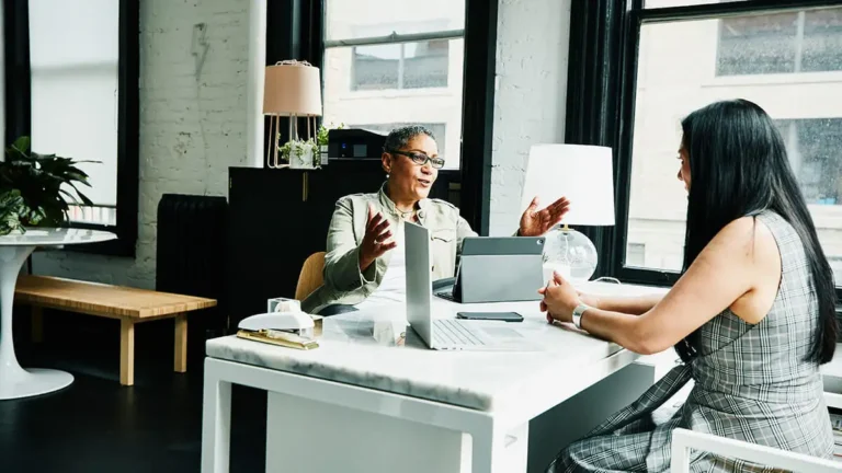 Business owner talking with employee