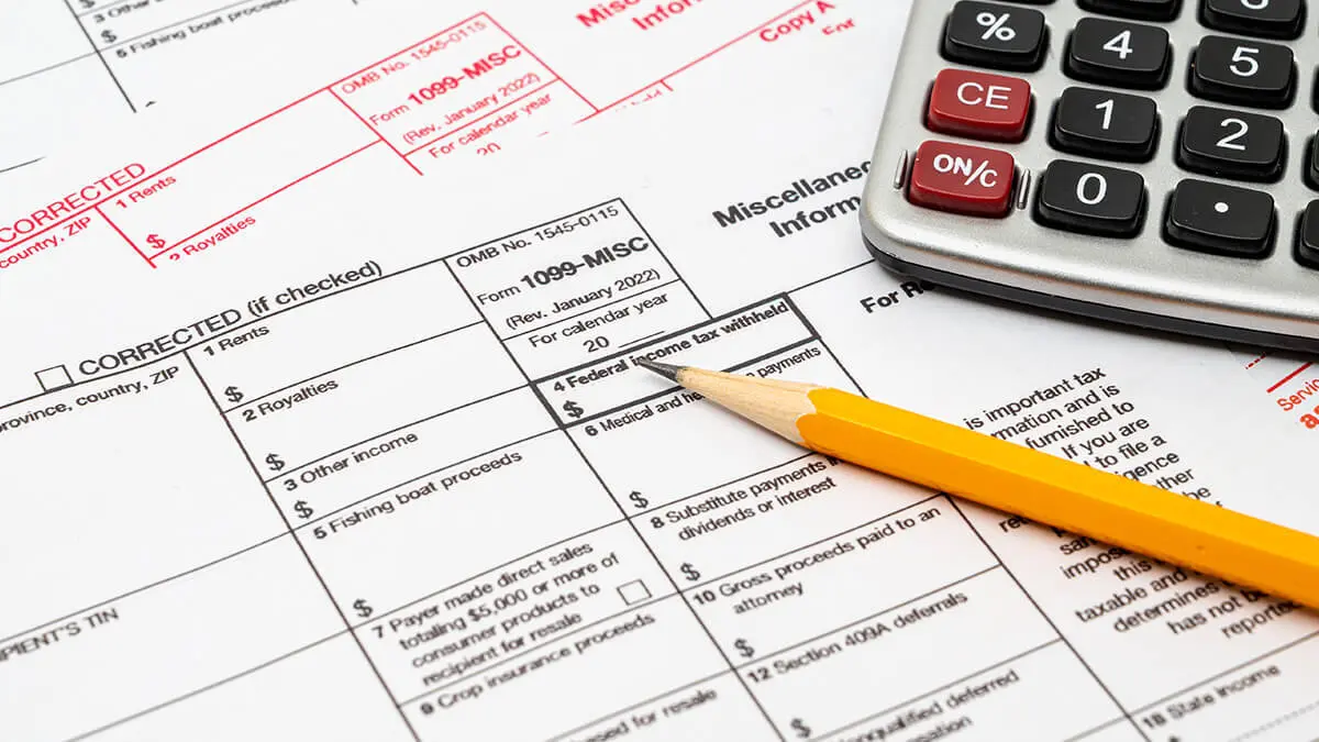 Form 1099 and a calculator and pencil.