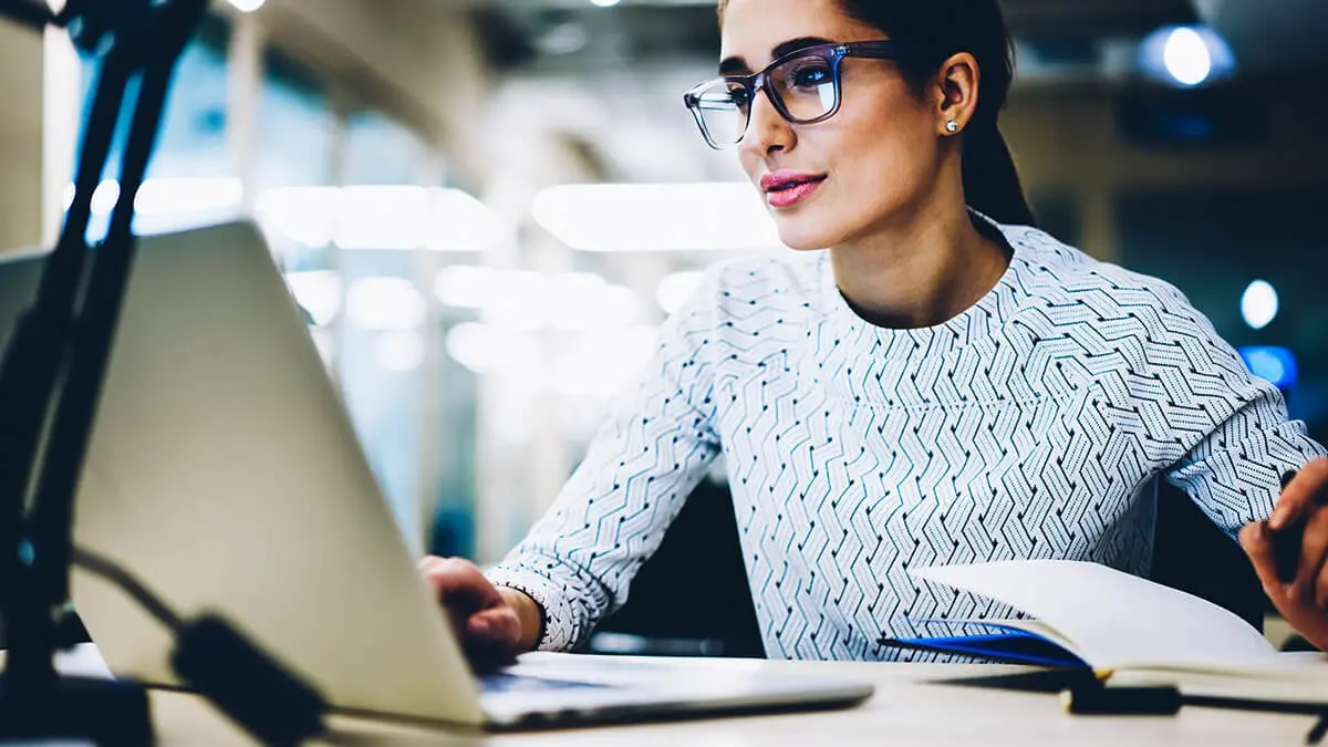 Business owner accounting for startup costs on her laptop.