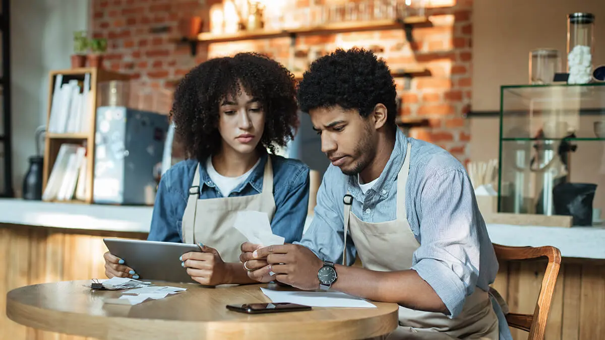 Two workers looking for accounting errors.