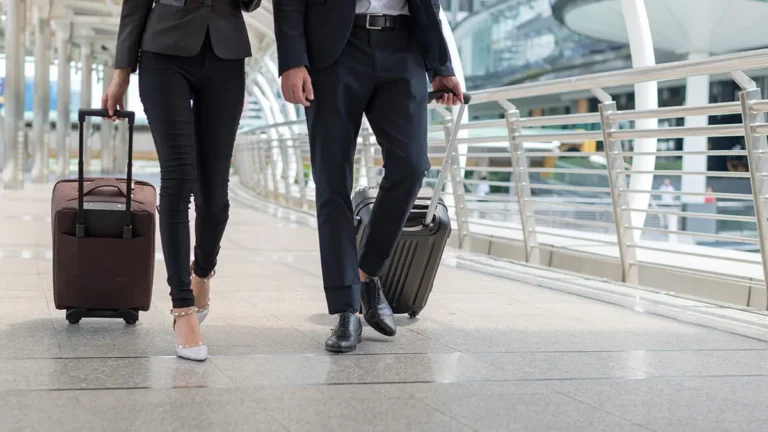 Two employees walk through an airport