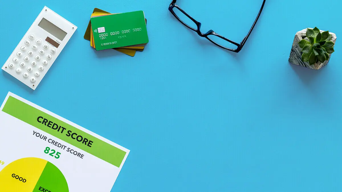 Miscellaneous objects like calculator, glasses, and credit cards on a blue background.