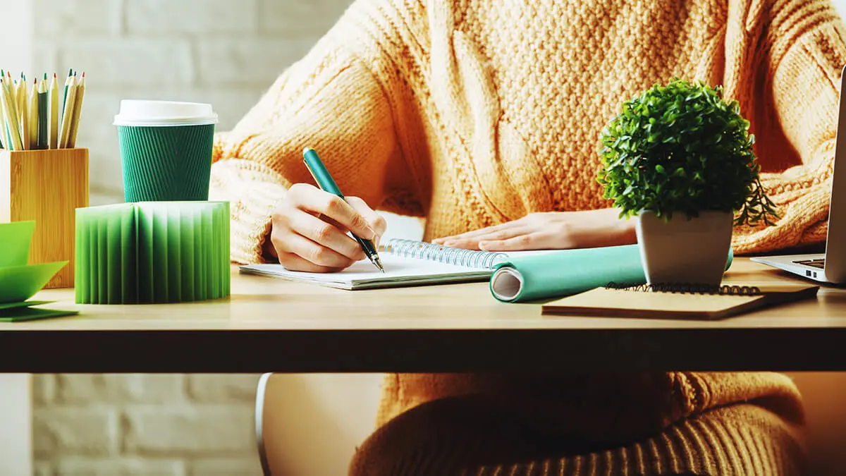 Business owner writing out her small business growth strategy.