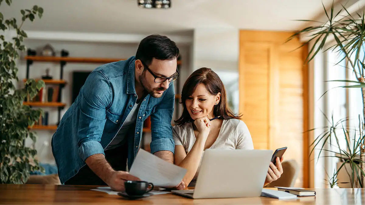 Two employees review paperwork together