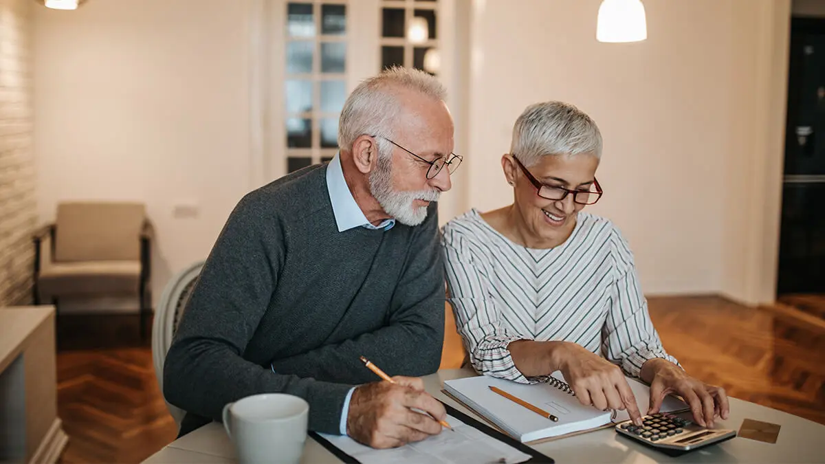 Older couple reviewing retirement plan features.