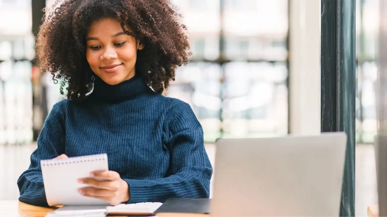 Smiling woman looking at notepad