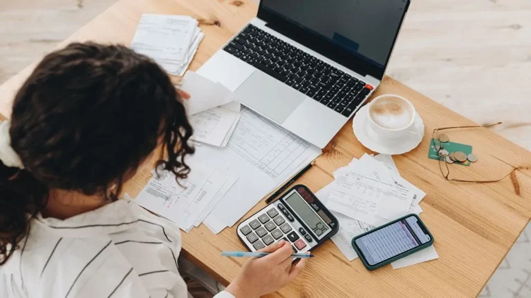 Woman using a laptop and calculator