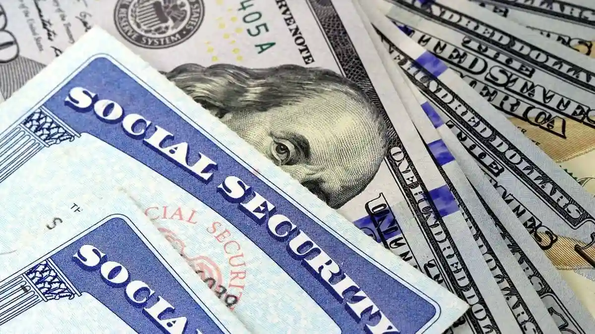 social security cards on top of cash