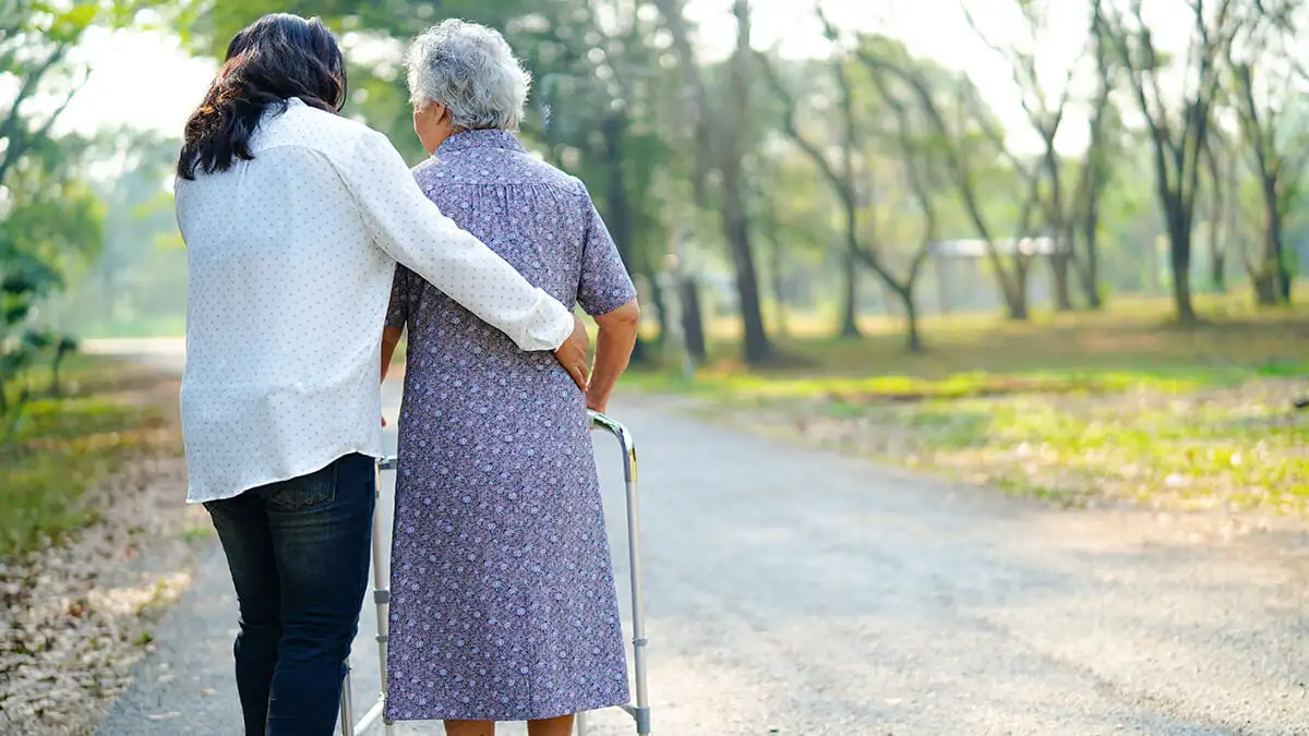 Woman walking with caretaker