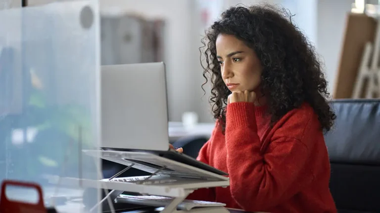 Woman learning how to fill out Form 944 on laptop