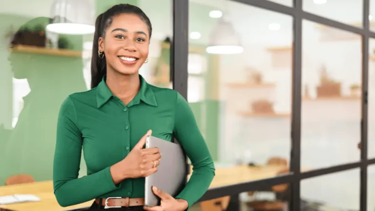 Smiling woman holding laptop