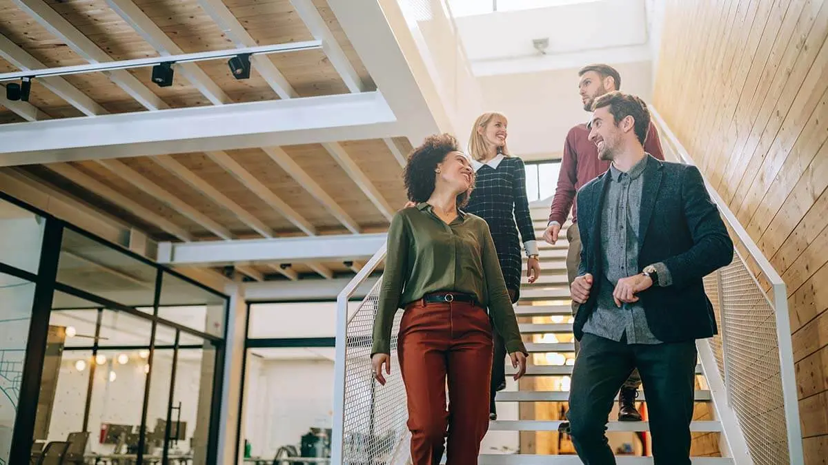 Four people walking down the stairs.