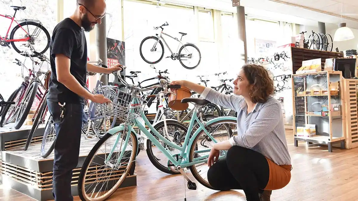 Bike store owner with a customer