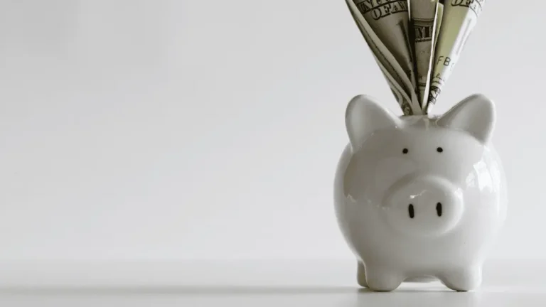 Piggy bank with money signifying payroll costs.