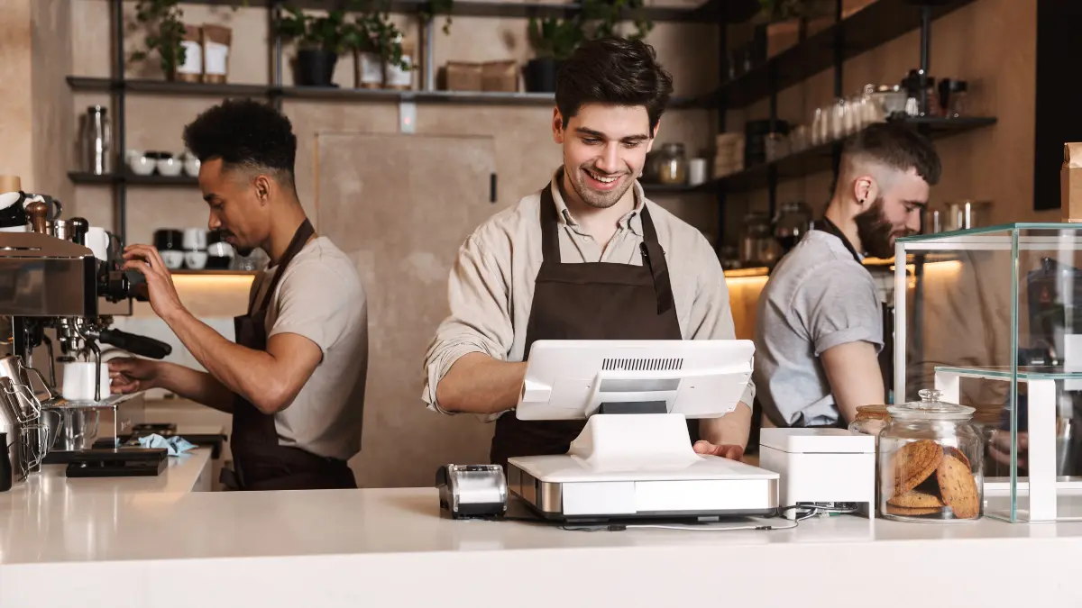 Three workers in a cafe.