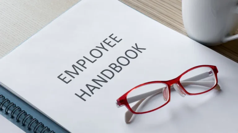 Employee handbook and red glasses