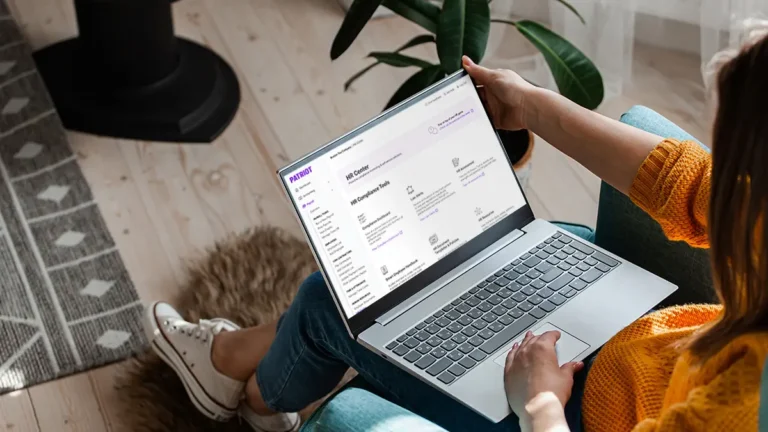 HR professional simplifying HR processes with Patriot's HR software.