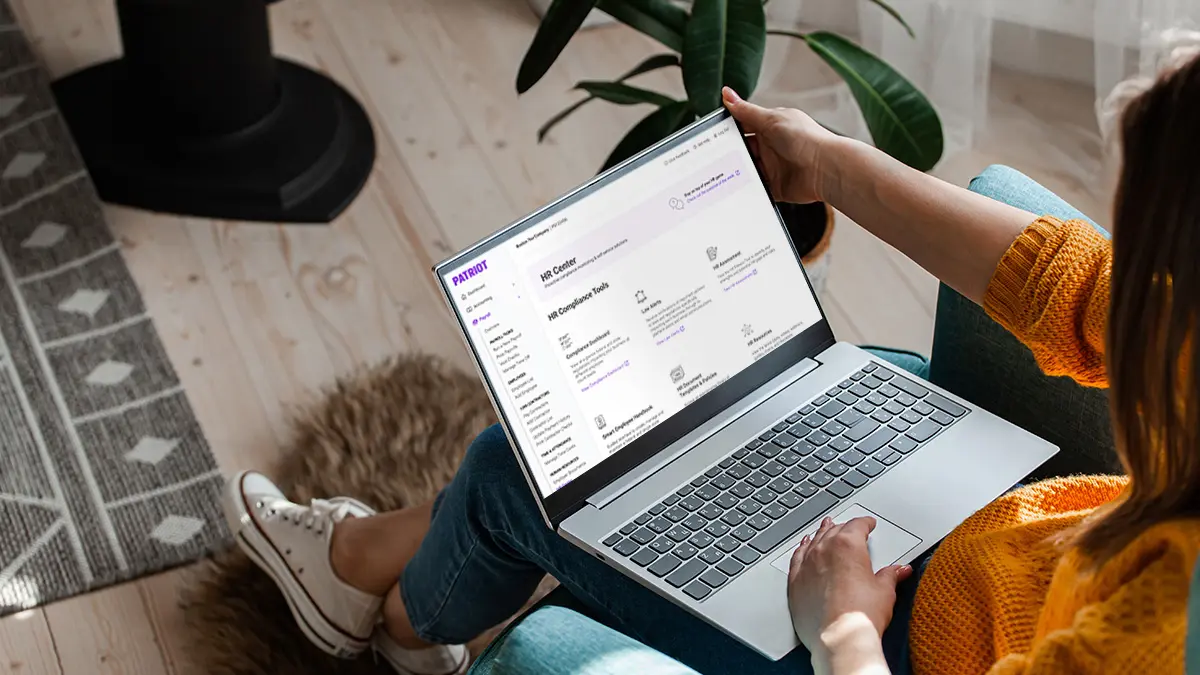 HR professional simplifying HR processes with Patriot's HR software.