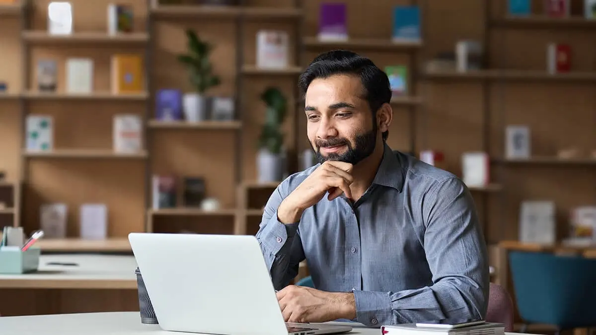 Man looking at HR software for small business on his laptop